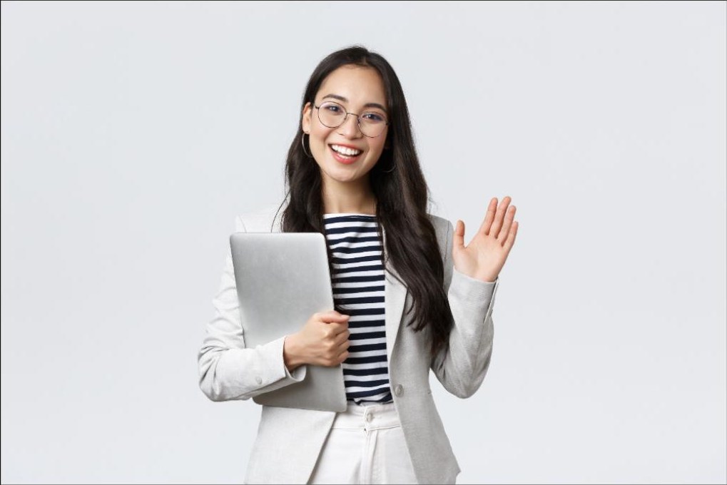 Smiling professional holding a laptop